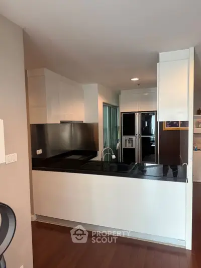 Modern kitchen with sleek black countertops and stainless steel appliances