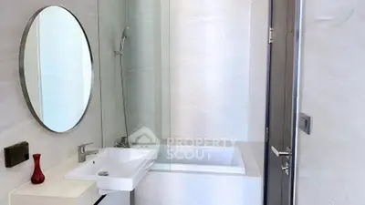 Modern bathroom with sleek design featuring a bathtub and stylish fixtures.