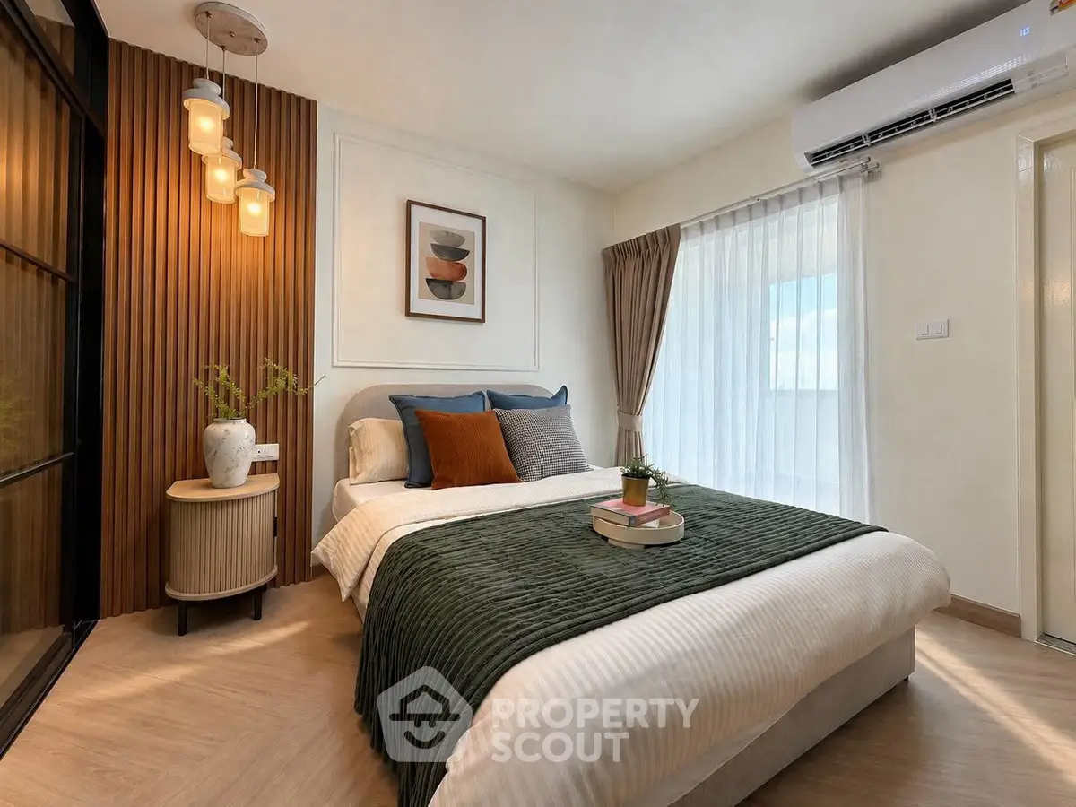 Stylish bedroom with modern decor and natural light in a cozy apartment.