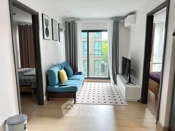 Modern living room with stylish decor and natural light in a contemporary apartment.