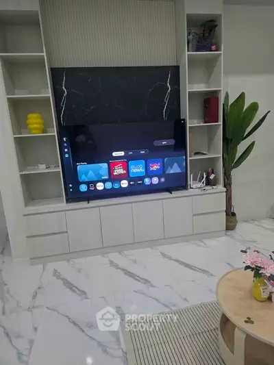 Modern living room with sleek TV setup and elegant marble flooring