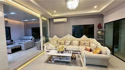 Luxurious living room with elegant sofa and modern decor, perfect for relaxation and entertainment.