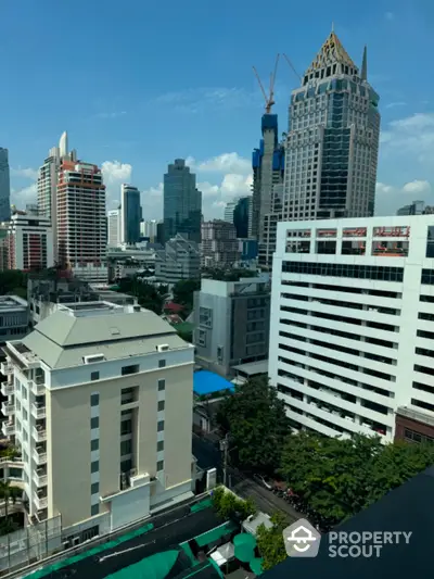 Stunning cityscape view with modern skyscrapers and lush greenery, perfect for urban living.