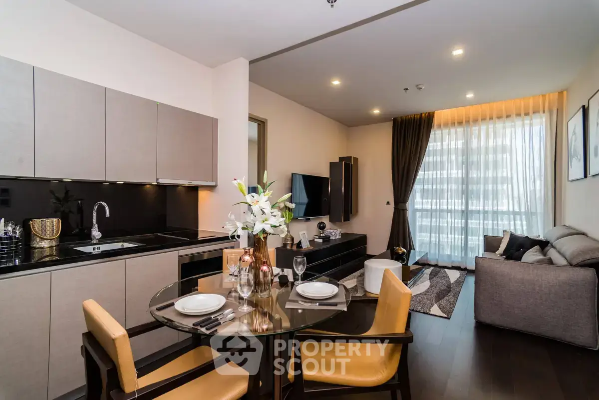 Modern open-plan living room and kitchen with elegant decor and natural light.