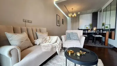 Elegant living room with plush seating and modern decor in a stylish apartment.