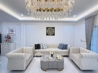 Luxurious living room with elegant chandelier and plush sofas
