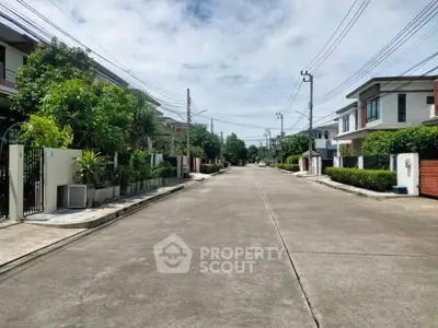 Charming suburban street with modern houses and lush greenery, ideal for family living.