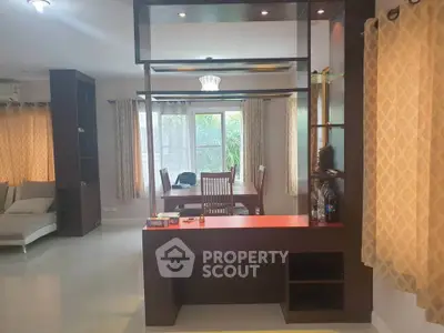 Spacious living room with modern dining area and large windows