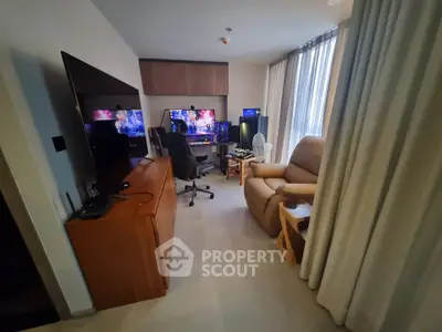 Modern living room with gaming setup and comfortable seating