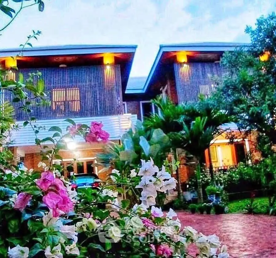 Charming two-story home with lush garden and modern architecture