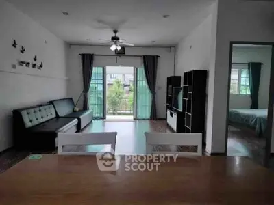 Spacious living room with modern decor and balcony view