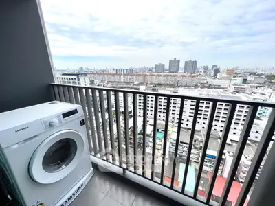 High-rise balcony with city view and washing machine, perfect for urban living.