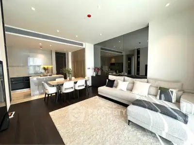 Luxurious open-plan living room with modern kitchen and elegant dining area in a stylish apartment.