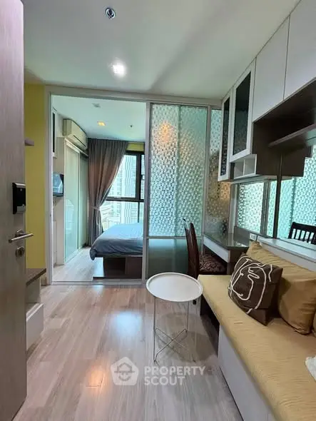 Modern apartment interior with cozy living area and bedroom, featuring stylish decor and natural light.