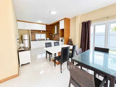 Spacious open-layout kitchen and dining area with modern furnishings and ample natural light.
