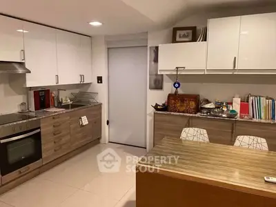 Modern kitchen with sleek cabinets and built-in oven, perfect for culinary enthusiasts.