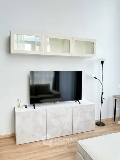 Modern living room with sleek TV setup and stylish storage cabinets