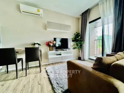 Modern living room with air conditioning, TV, and balcony access, featuring stylish decor and natural light.
