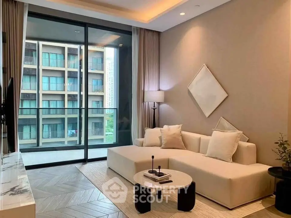 Modern living room with elegant decor and large balcony view in luxury apartment.