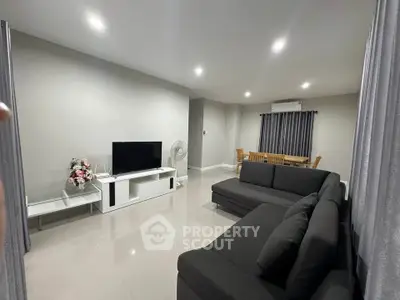 Spacious modern living room with sleek furniture and dining area