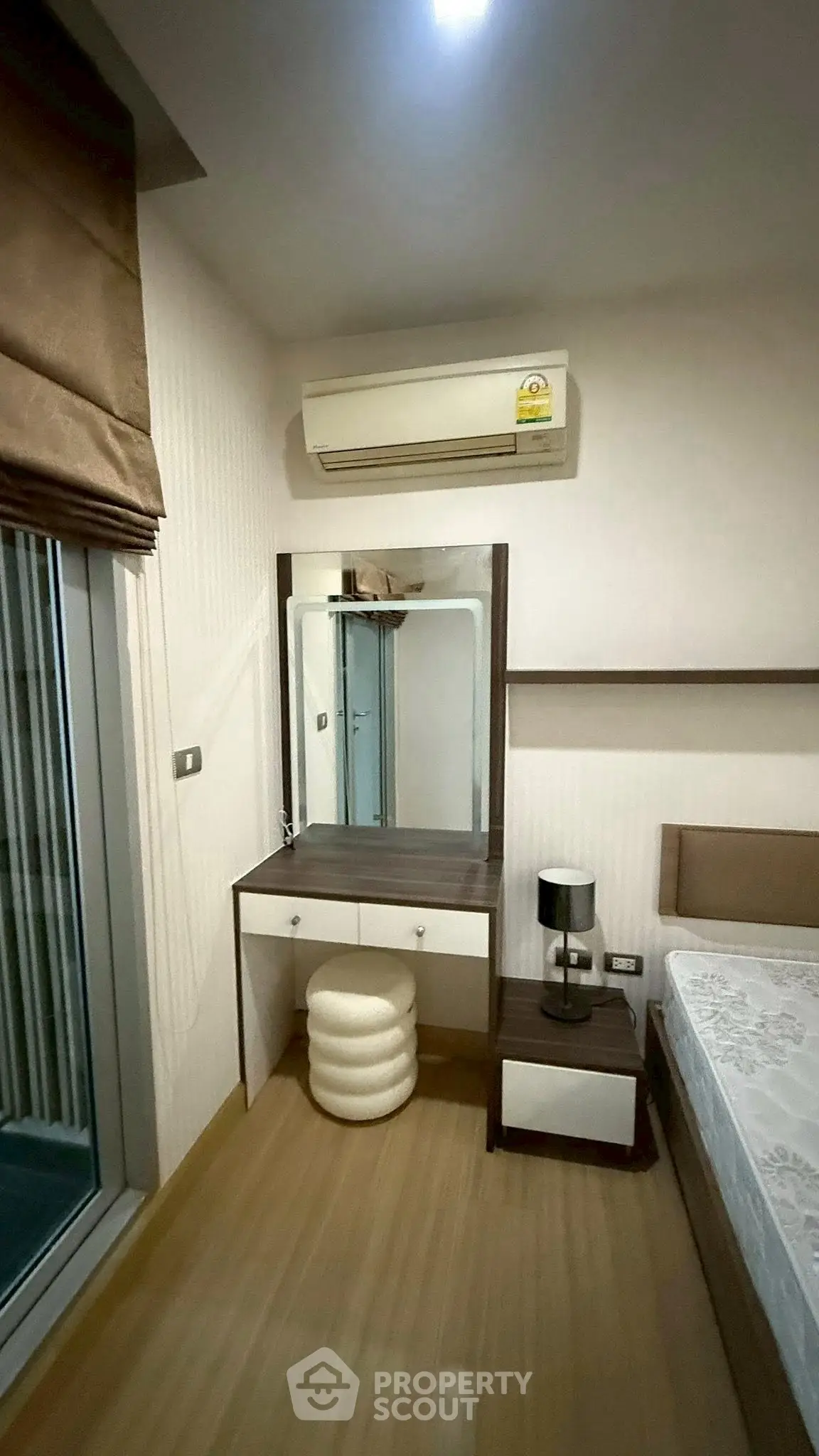 Cozy bedroom with air conditioning and modern furniture in a stylish apartment.