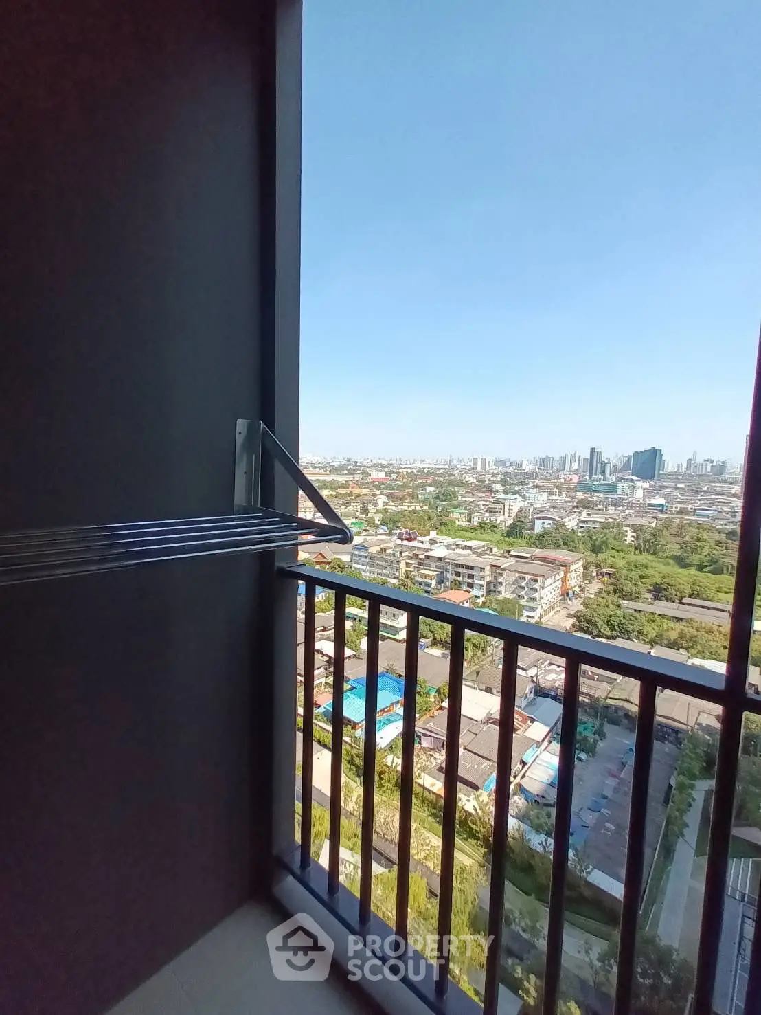 Stunning cityscape view from a modern high-rise balcony with sleek architectural design.