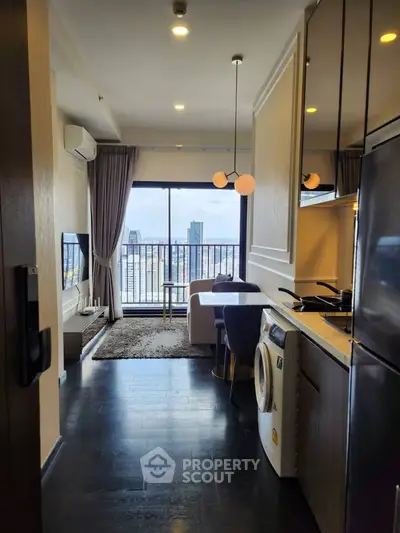 Modern apartment with open kitchen and living area, featuring city view and stylish furnishings.