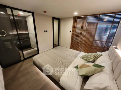 Modern bedroom with sleek design and wooden accents, featuring a cozy bed and stylish sliding doors.