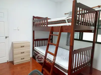 Cozy bedroom with bunk beds and wooden flooring