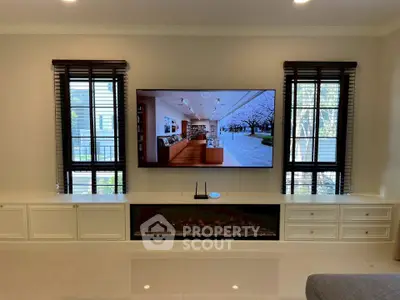 Elegant living room with large TV and modern decor