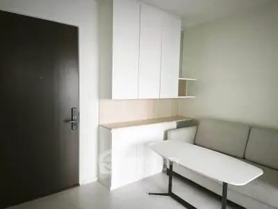 Modern apartment interior with sleek storage and cozy seating area