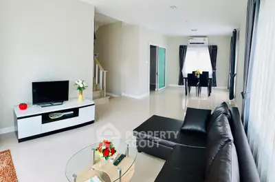Spacious modern living room with sleek furniture and dining area, perfect for family gatherings.