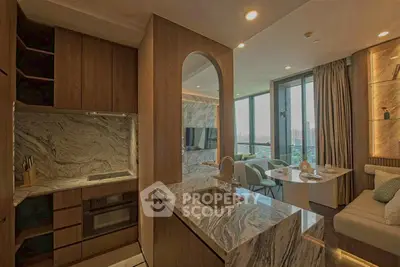 Luxurious open-layout kitchen with marble countertops and modern dining area.