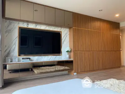 Luxurious modern living room with sleek wood paneling and large TV