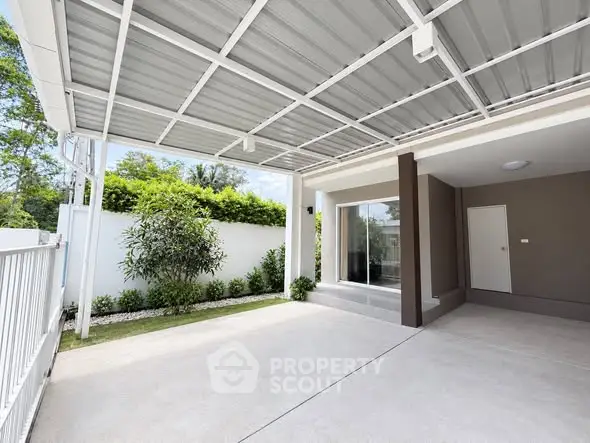 Modern covered parking area with sleek design and lush greenery