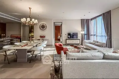 Luxurious open-plan living and dining area with elegant furnishings and natural light.