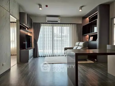 Modern living room with sleek design, large windows, and stylish furniture in a contemporary apartment.