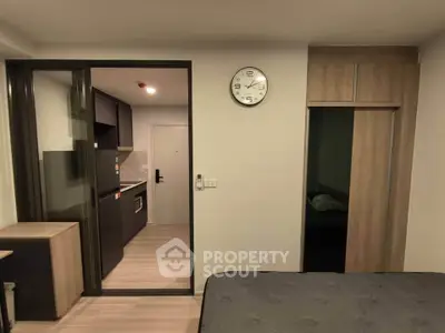 Modern studio apartment with sleek kitchen and cozy bedroom