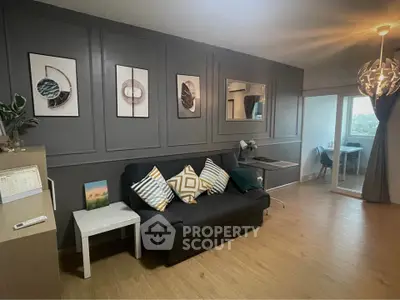 Modern living room with stylish decor and cozy seating area, featuring elegant wall art and natural light.