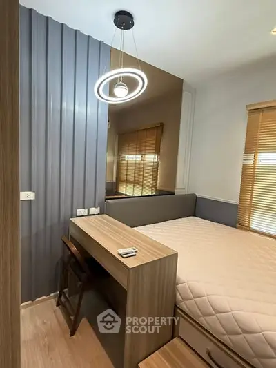 Modern bedroom with stylish lighting and wooden furniture, featuring a cozy bed and elegant blinds.