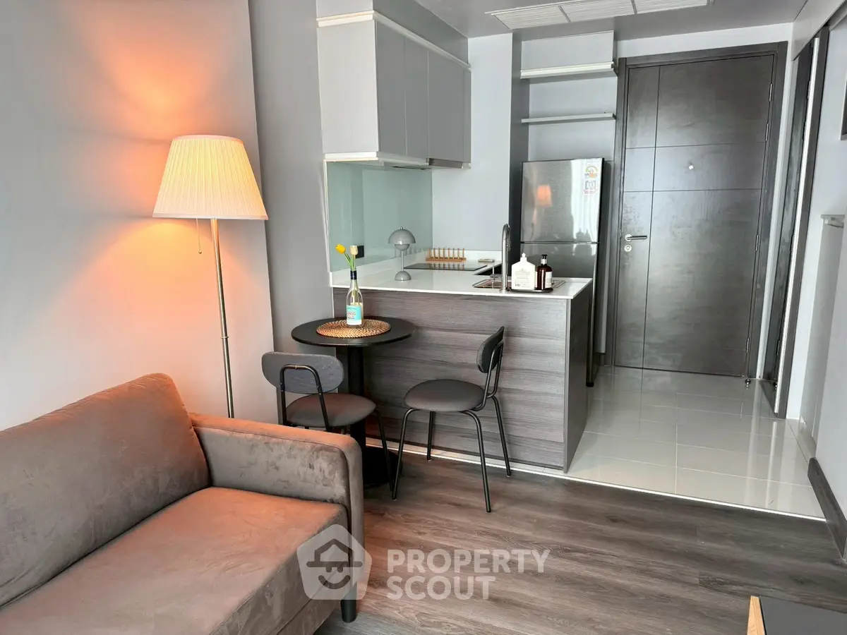 Modern compact living room with cozy sofa and stylish kitchen area