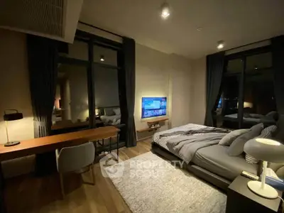 Luxurious bedroom with modern decor and large windows offering stunning night views.