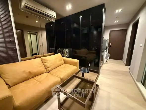 Modern living room with sleek black cabinets and cozy yellow sofa in stylish apartment.
