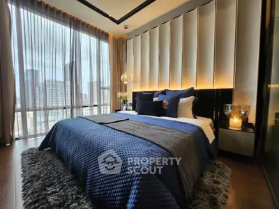 Luxurious bedroom with city view, featuring elegant decor and plush bedding in a modern high-rise apartment.