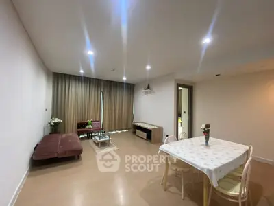 Spacious living room with elegant decor and dining area