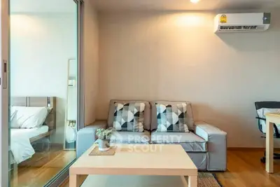 Modern living room with cozy sofa and stylish decor in a contemporary apartment.