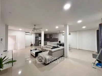 Spacious modern living room with open kitchen and sleek furnishings
