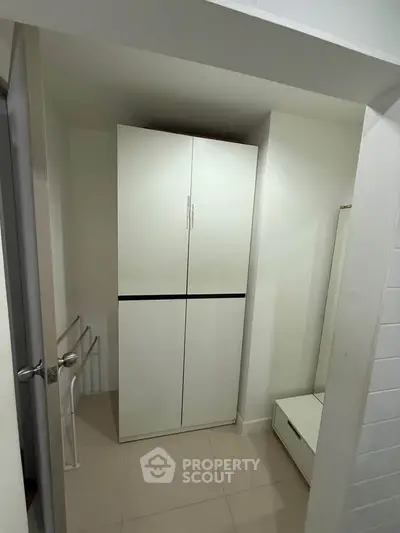 Compact storage space with white cabinet and modern design