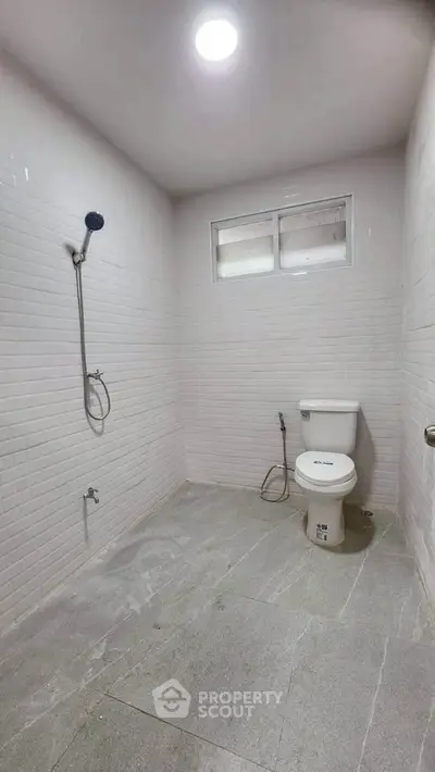 Minimalist bathroom with white tiles and modern fixtures