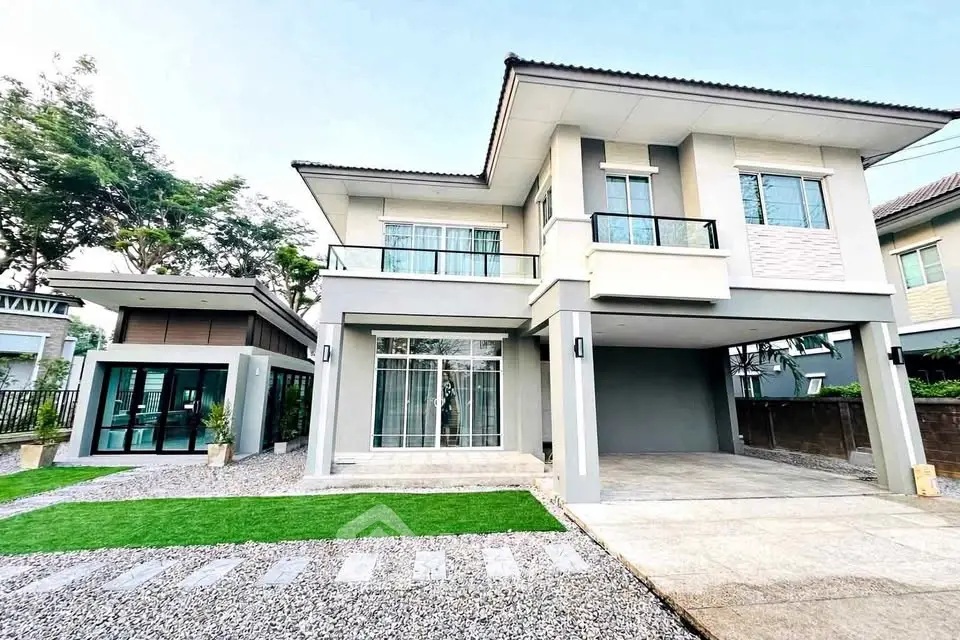 Modern two-story house with spacious driveway and lush green lawn